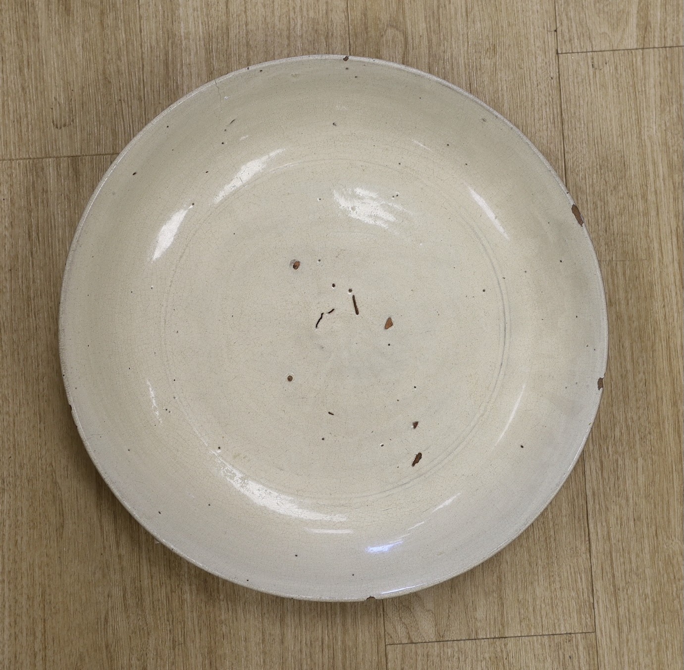 A large and rare Burmese cream crackle glazed dish, Tak region, 16th/17th century, 44cm, ex Lammers Collection, previously sold by Gorringes in 2014.